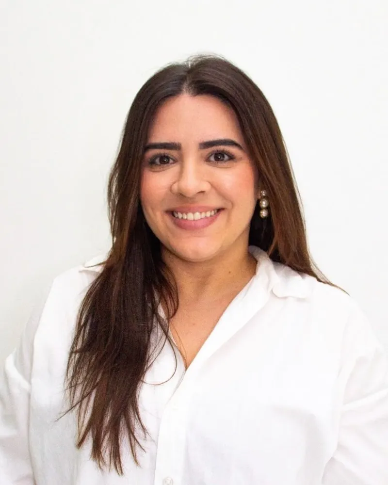 Ayara paediatric nurse smiling in a white shirt